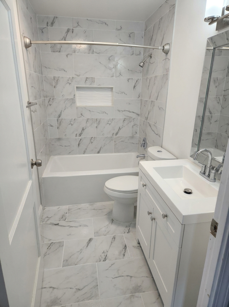 Modern bathroom renovation featuring custom tile work and walk-in shower by HBO Construction